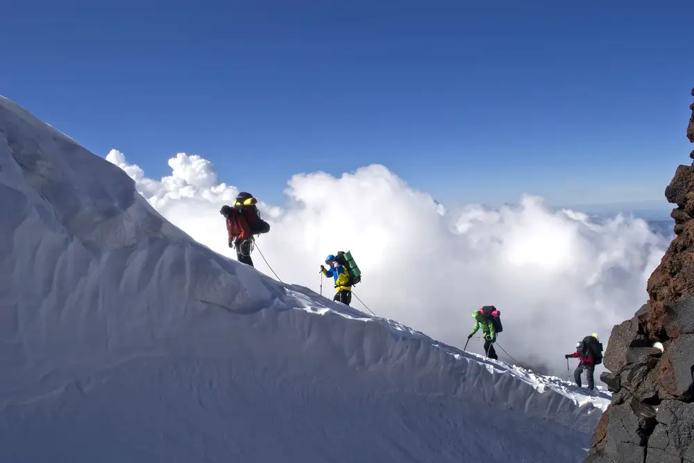 Team ascending a ridge representing disciplined execution and leadership
